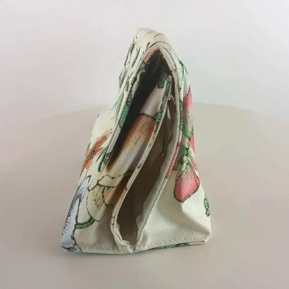 Clinique cream floral print fold over makeup / jewelry bag.